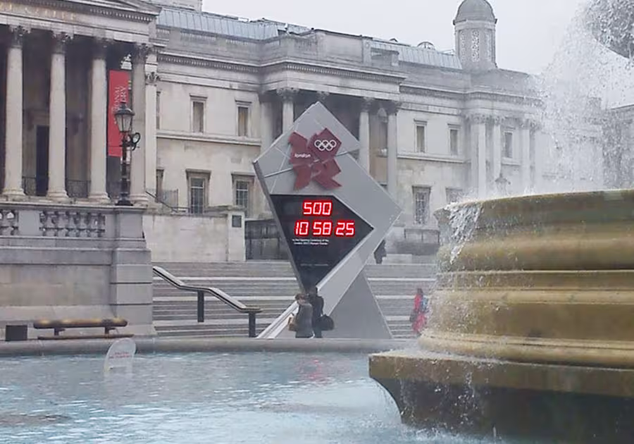 Countdown clock marking the start of the Olympic Games, erected like a megalith on the edge of Trafalgar Square, along the Strand alignment.