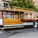 Plaque tournante du Cable Car Powell-Mason, là où le tracé de l’ennéagone dévie de l’avenue Columbus pour suivre l’orientation principale des rues de San Francisco. Photo : Dietmar Rabich, CC BY-SA 4.0.
